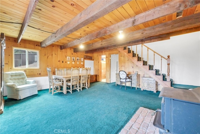 interior space with wooden walls, beam ceiling, and wooden ceiling