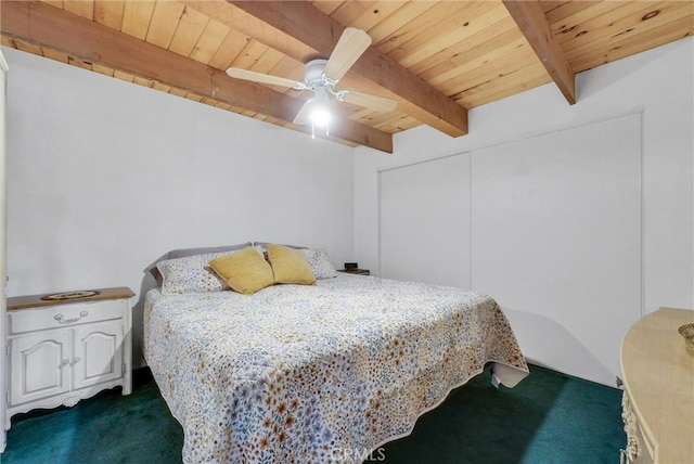 carpeted bedroom with ceiling fan, beam ceiling, and wood ceiling