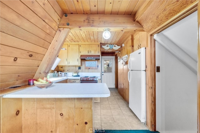 kitchen with custom range hood, wooden ceiling, kitchen peninsula, white fridge, and wood walls