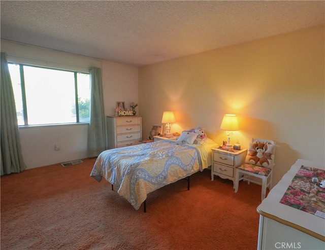 carpeted bedroom featuring a textured ceiling