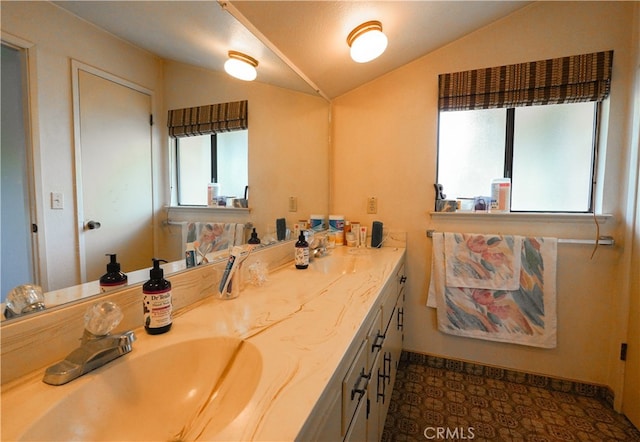 bathroom featuring lofted ceiling and vanity