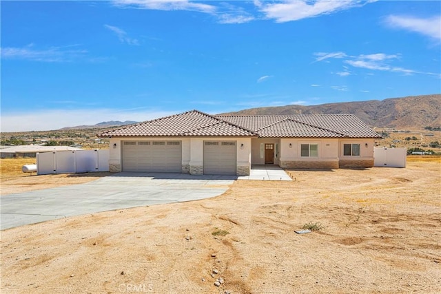 view of front of property featuring a mountain view and a garage