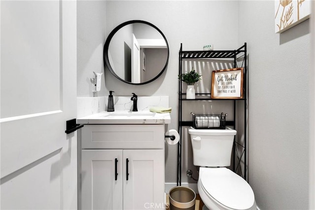 bathroom featuring toilet and vanity