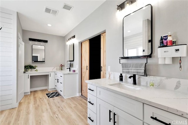 bathroom featuring hardwood / wood-style flooring and vanity