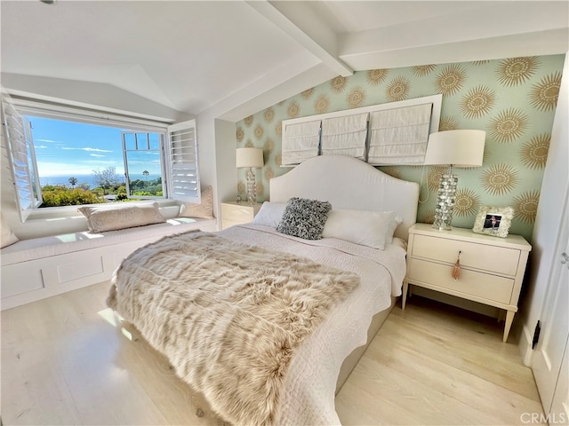 bedroom featuring vaulted ceiling with beams and light hardwood / wood-style flooring