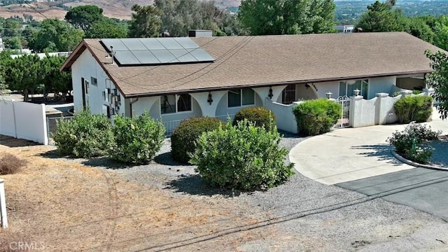 view of front of property with solar panels