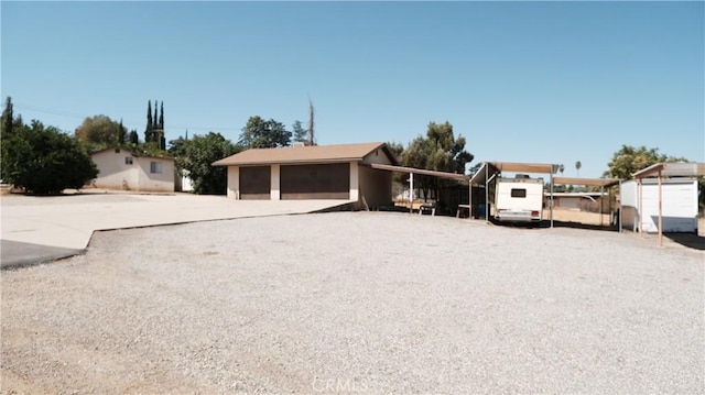 view of front facade featuring a garage and an outdoor structure