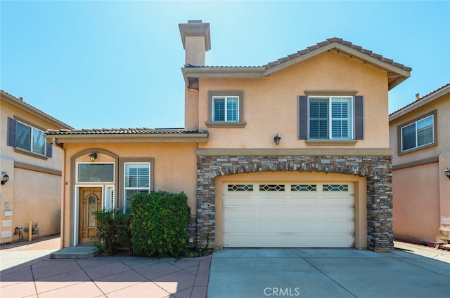 mediterranean / spanish-style home with a garage