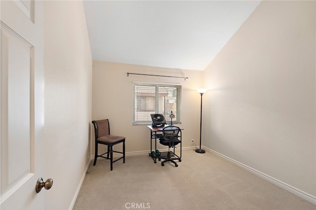 carpeted office featuring vaulted ceiling