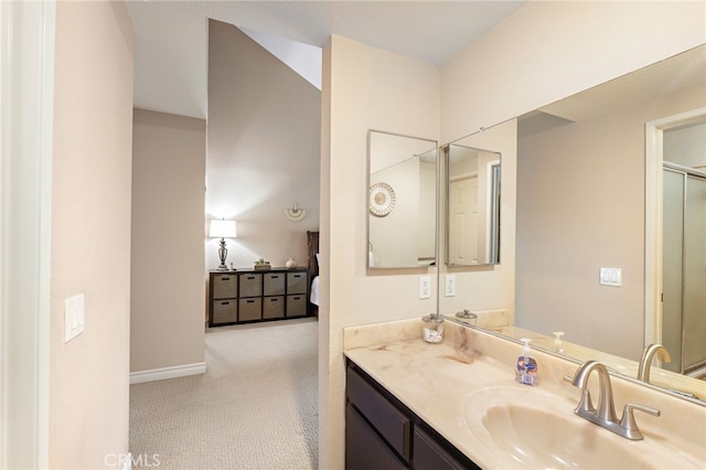 bathroom with vanity and a shower with door