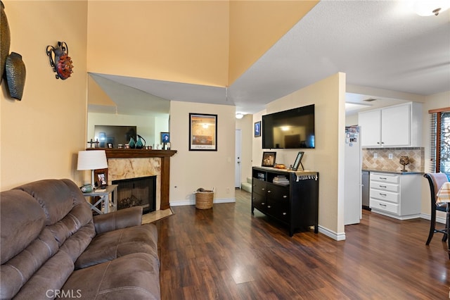 living room featuring dark hardwood / wood-style flooring and a high end fireplace