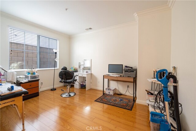 home office featuring crown molding and hardwood / wood-style flooring