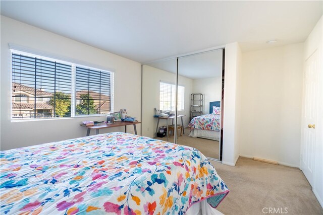 carpeted bedroom featuring a closet