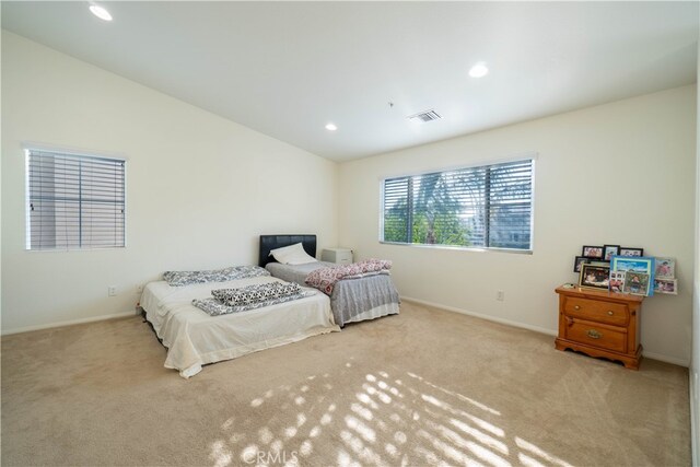 carpeted bedroom featuring lofted ceiling