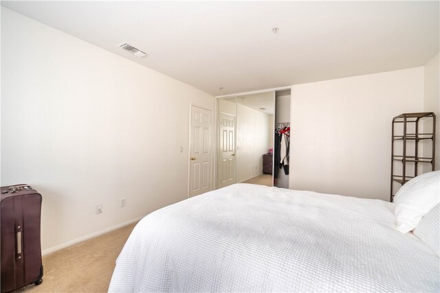 carpeted bedroom featuring a closet