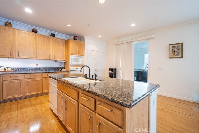 kitchen with white appliances, crown molding, light hardwood / wood-style flooring, a center island with sink, and sink