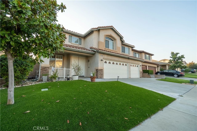 view of front of house with a garage and a front lawn