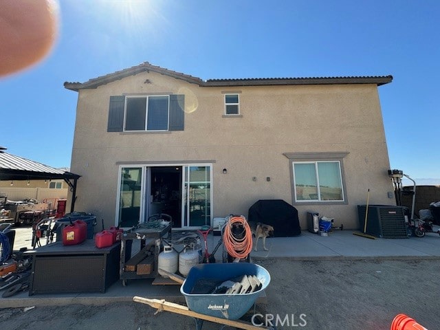 back of property with a patio and cooling unit