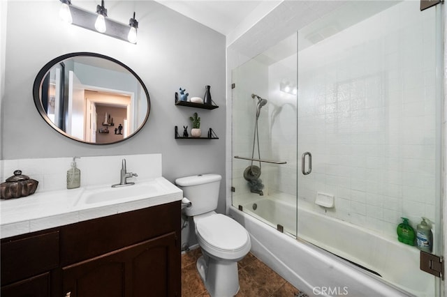 full bathroom featuring shower / bath combination with glass door, toilet, vanity, and tile patterned floors