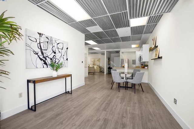 dining space featuring wood-type flooring