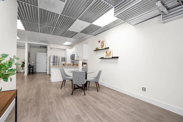 dining area with light hardwood / wood-style floors