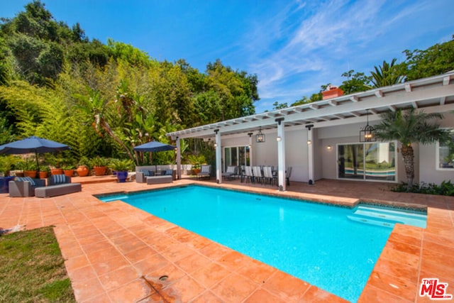 view of pool featuring outdoor lounge area, a pergola, and a patio