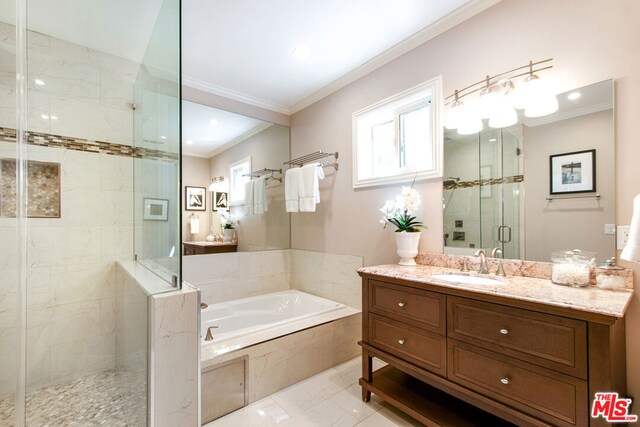 bathroom with independent shower and bath, vanity, and crown molding