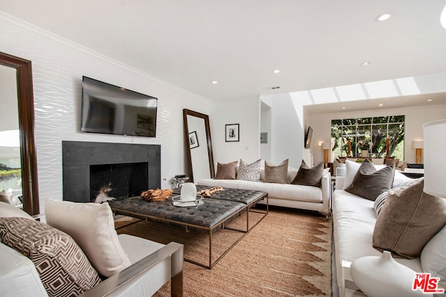 living room featuring a premium fireplace and crown molding