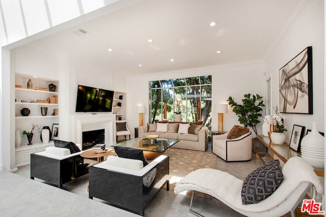 living room with built in shelves and crown molding