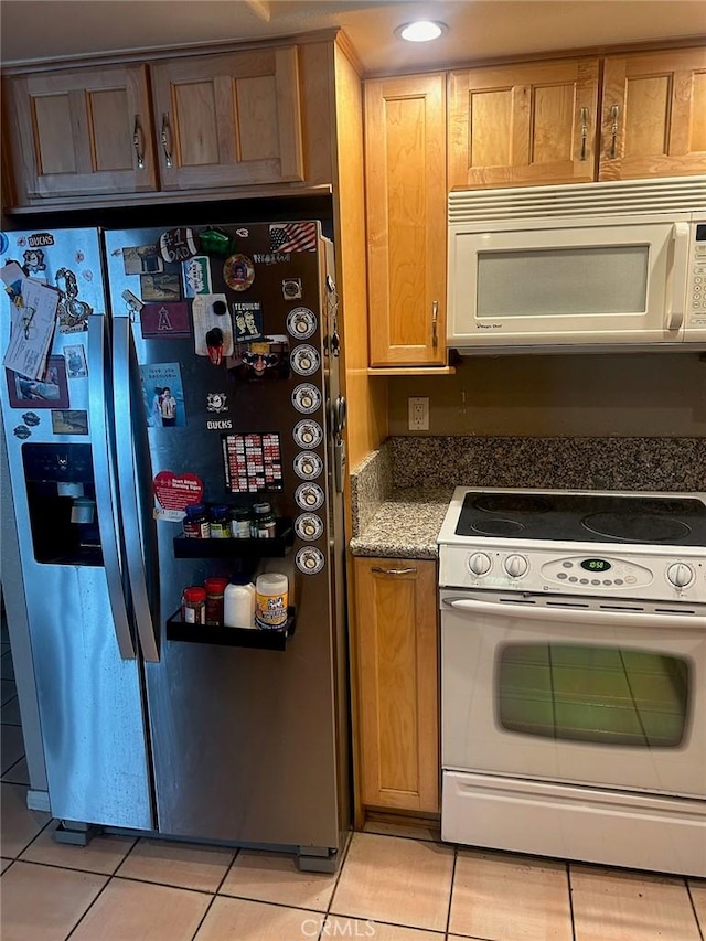 kitchen with white appliances and light tile patterned floors