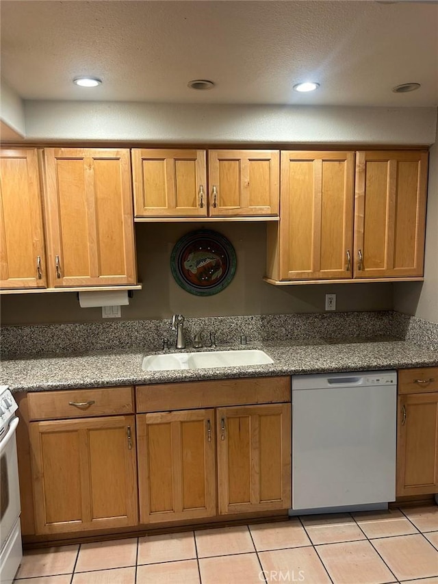 kitchen featuring stone counters, sink, a textured ceiling, white appliances, and light tile patterned floors