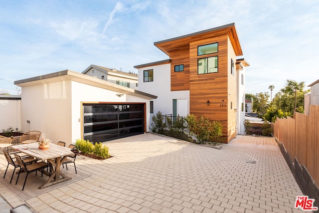 rear view of house with a garage