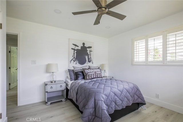 bedroom with ceiling fan and light wood-type flooring