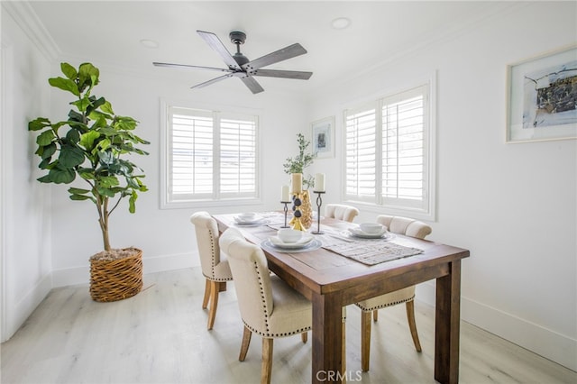 dining area with light wood-type flooring, ceiling fan, and crown molding