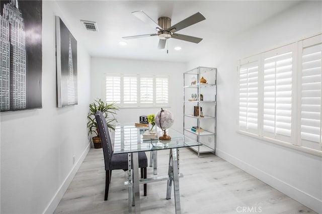 dining space with ceiling fan and light hardwood / wood-style floors