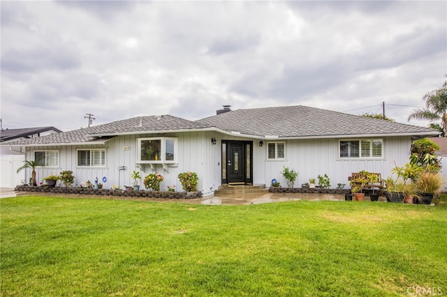 rear view of property with a lawn