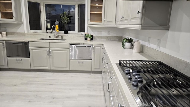 18672 Spaulding Ave, North Tustin, CA 92705 - kitchen featuring stainless steel appliances, glass insert cabinets, light countertops, and white cabinets