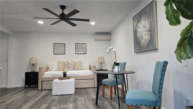 living room featuring an AC wall unit, ceiling fan, dark wood-type flooring, and a textured ceiling