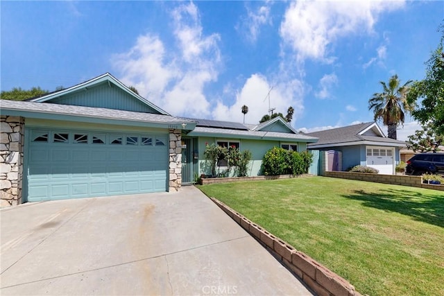 ranch-style home featuring a front lawn, a garage, and solar panels