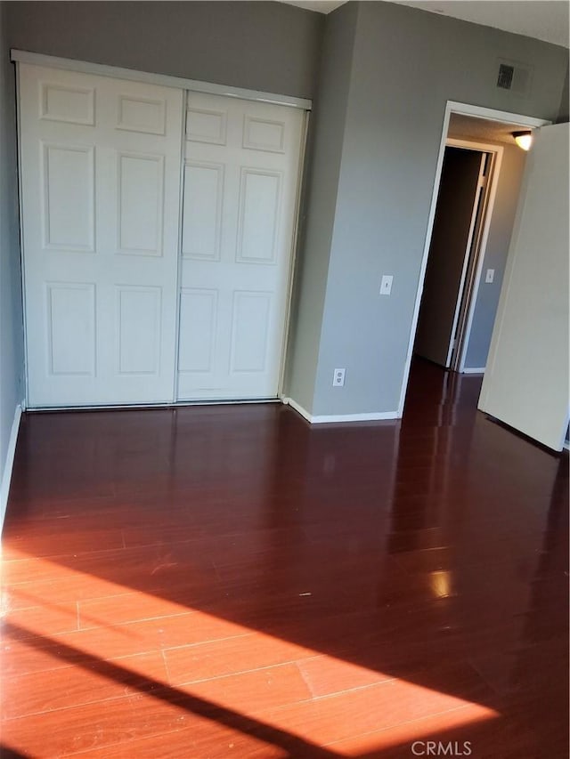 spare room featuring dark hardwood / wood-style flooring