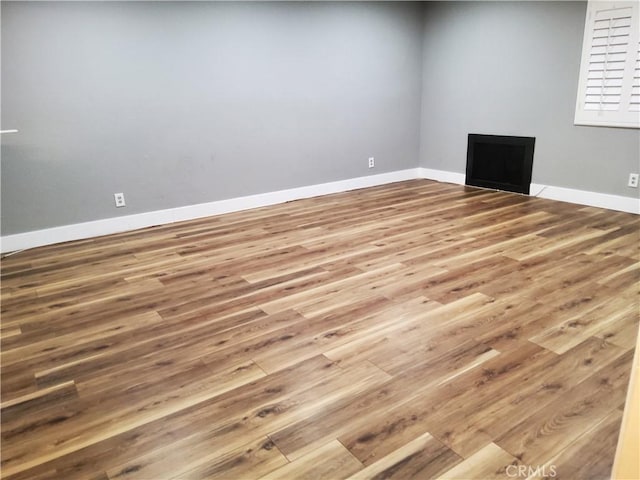 empty room with hardwood / wood-style flooring