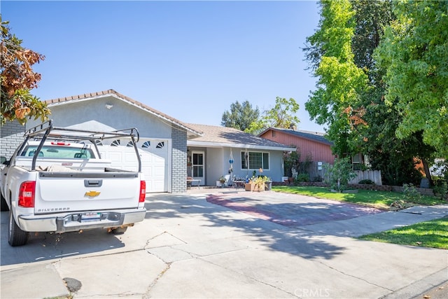 ranch-style home featuring a front yard and a garage