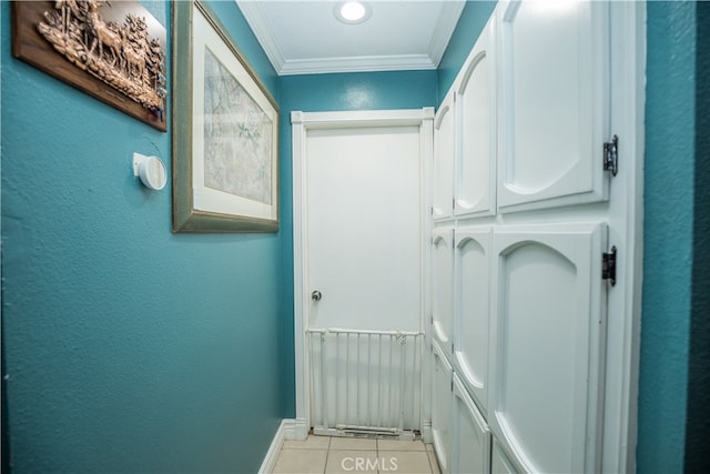 hallway with crown molding and light tile patterned floors