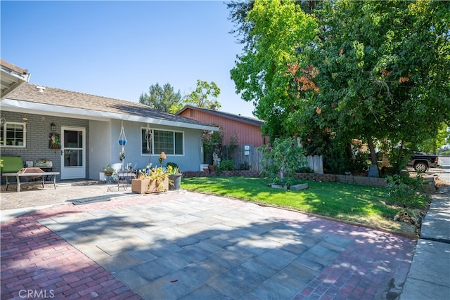 exterior space with a lawn and a patio area