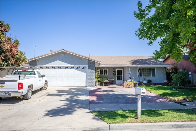 ranch-style house featuring a garage and a front lawn