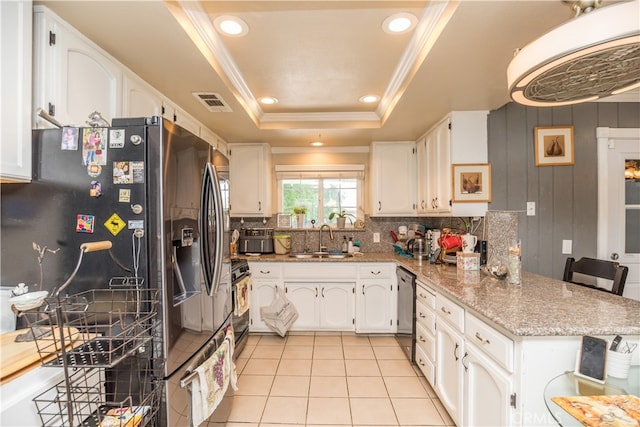 kitchen featuring white cabinetry, a raised ceiling, appliances with stainless steel finishes, and sink