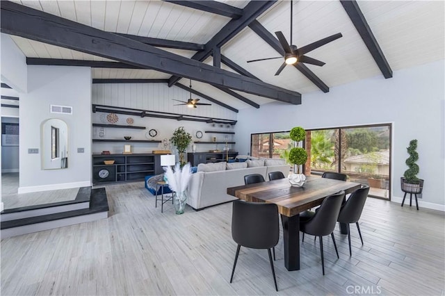 dining room featuring beamed ceiling, light wood-type flooring, and high vaulted ceiling