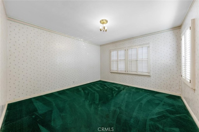 carpeted spare room featuring a healthy amount of sunlight and ornamental molding