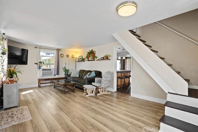 living room featuring cooling unit and light wood-type flooring