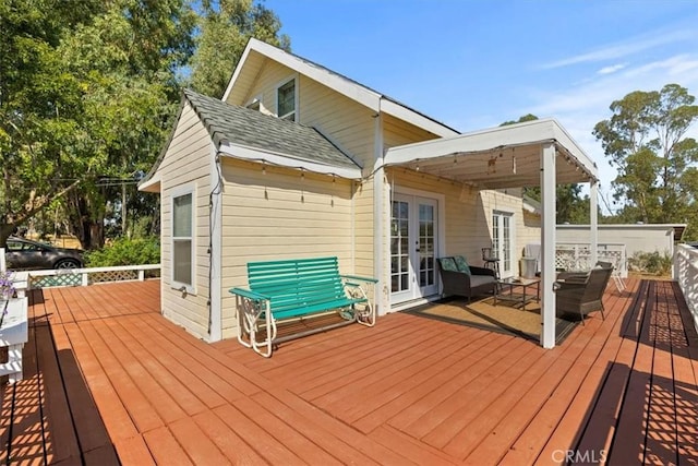 wooden terrace featuring french doors and an outdoor living space